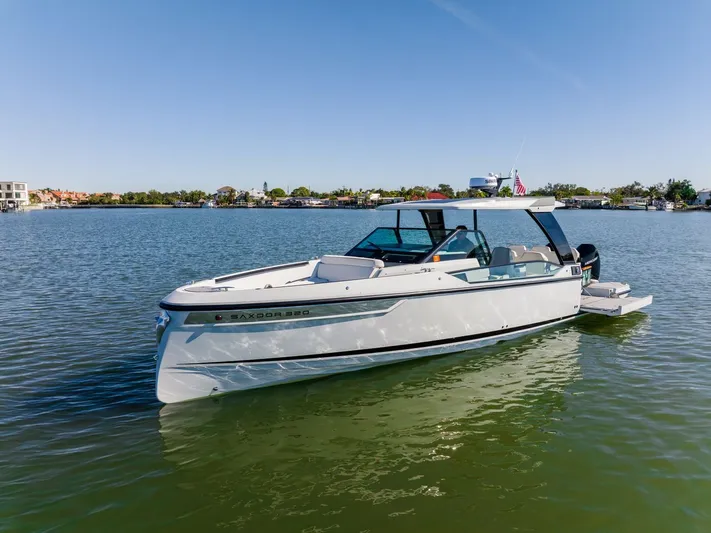 Yacht Photos Pics 2024 Saxdor 320 GTO boat on calm water, showcasing sleek design and modern features.
