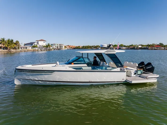  Yacht Photos Pics 2024 Saxdor 320 GTO boat on calm water, showcasing sleek design and modern features.