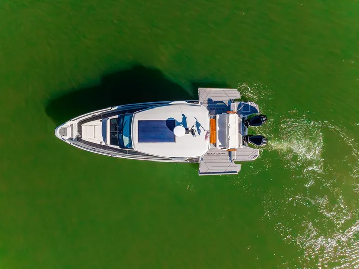  Yacht Photos Pics Overhead view of 2024 Saxdor 320 GTO boat cruising on green water.