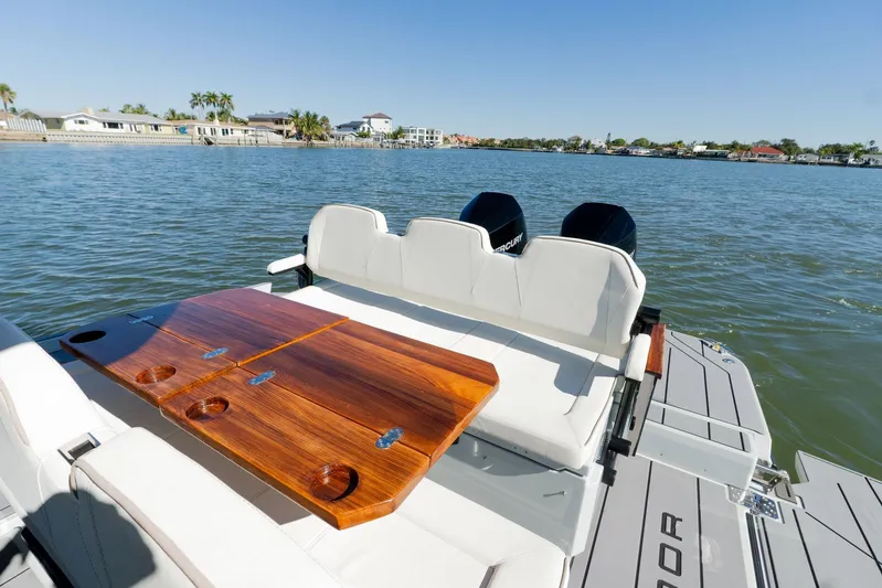  Yacht Photos Pics 2024 Saxdor 320 GTO boat with elegant seating and wooden table on a sunny day.