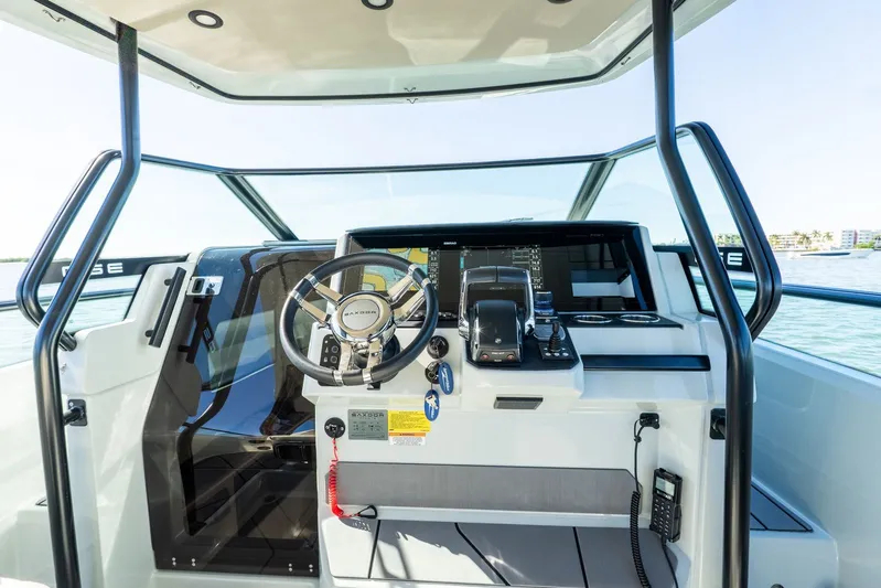  Yacht Photos Pics 2024 Saxdor 320 GTO helm with modern controls and steering wheel, overlooking serene waters.