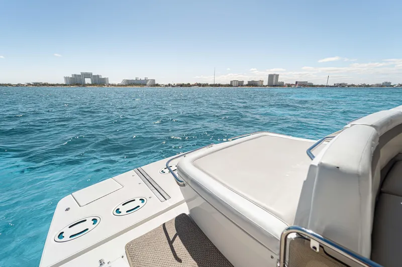 Atm 2013 Sea Ray 450 Sundancer @ Cancun Yacht Photos Pics 2013 Sea Ray 450 Sundancer yacht on blue water with city skyline in background.