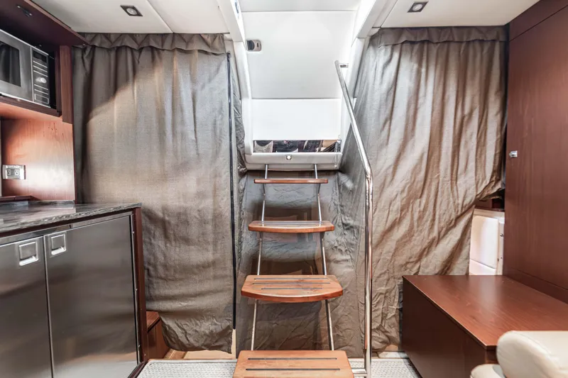 Atm 2013 Sea Ray 450 Sundancer @ Cancun Yacht Photos Pics Interior of 2013 Sea Ray 450 Sundancer yacht with wooden stairs and modern kitchen amenities.