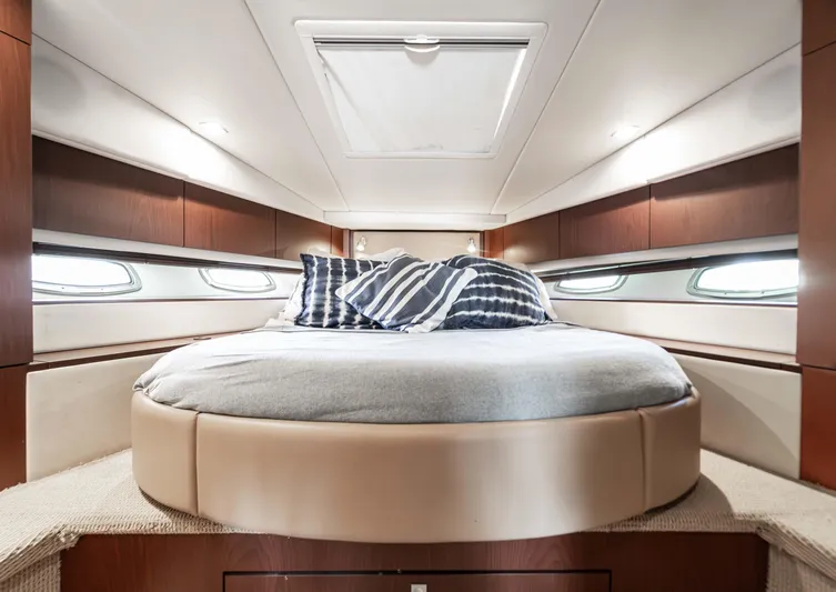 Atm 2013 Sea Ray 450 Sundancer @ Cancun Yacht Photos Pics Luxurious cabin interior of 2013 Sea Ray 450 Sundancer yacht with round bed and striped pillows.