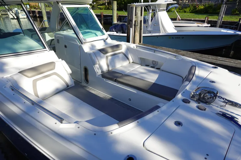  Yacht Photos Pics 2019 World Cat 320 DC boat with spacious seating and sleek design at a dock.