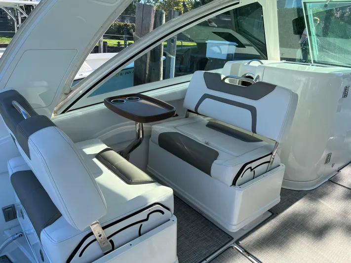  Yacht Photos Pics 2019 World Cat 320 DC boat interior with white seating and small table.
