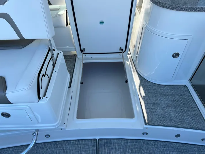  Yacht Photos Pics 2019 World Cat 320 DC boat interior storage compartment with open hatch and seating.