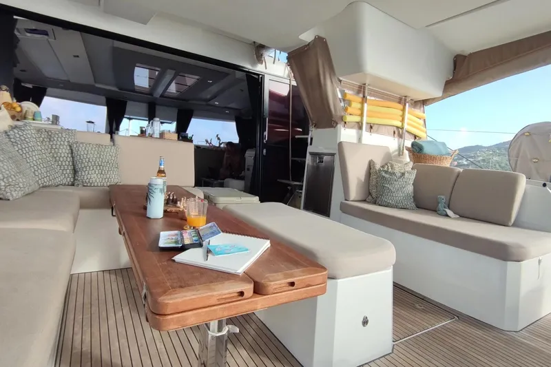 Beyond Yacht Photos Pics Luxurious 2022 Fountaine Pajot Aura 51 yacht interior with cozy seating and elegant decor.