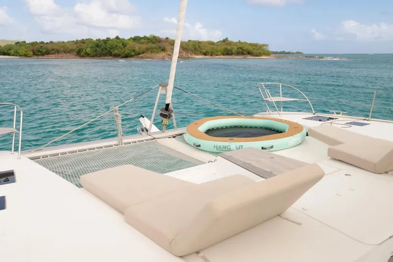 Beyond Yacht Photos Pics Luxurious 2022 Fountaine Pajot Aura 51 yacht with sun loungers and inflatable pool on deck.