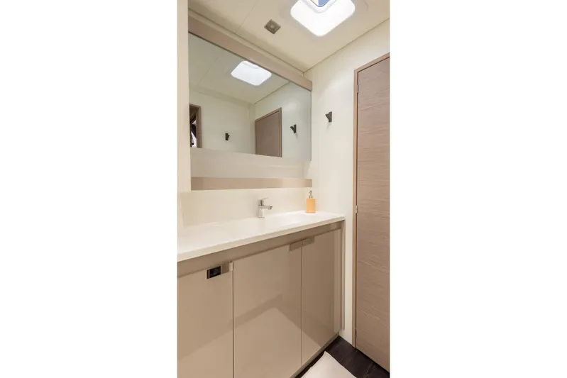 Beyond Yacht Photos Pics Modern bathroom interior of 2022 Fountaine Pajot Aura 51 yacht, featuring sleek design and fixtures.
