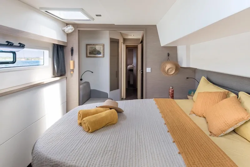 Beyond Yacht Photos Pics Luxurious bedroom interior of 2022 Fountaine Pajot Aura 51 yacht with cozy bedding.