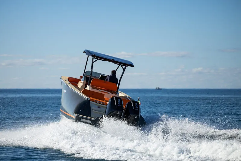  Yacht Photos Pics 2025 AlCustom LIPARI 31 boat cruising on open water, creating a wake.