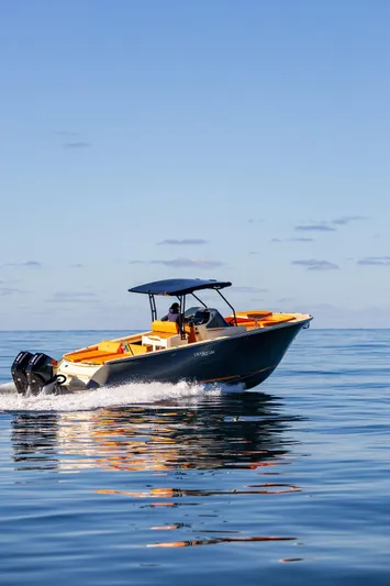  Yacht Photos Pics 2025 AlCustom LIPARI 31 boat cruising on calm ocean waters under clear blue sky.