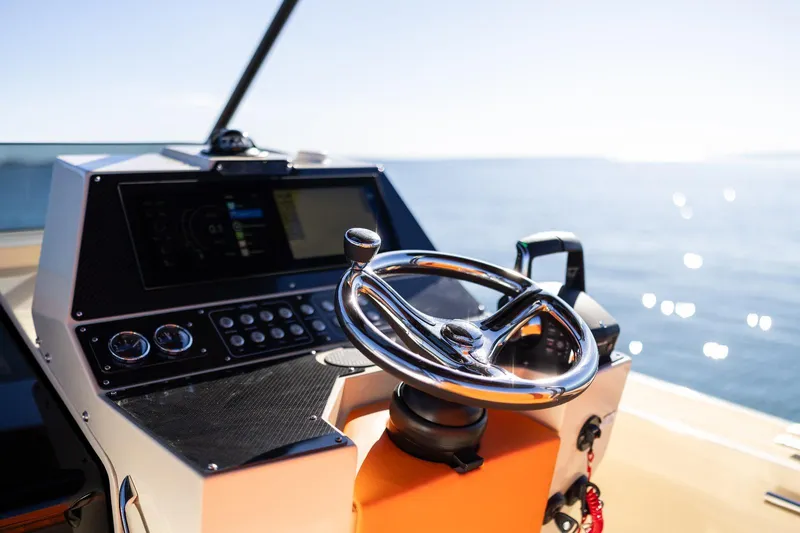  Yacht Photos Pics 2025 AlCustom LIPARI 31 boat helm with steering wheel and control panel, ocean view.
