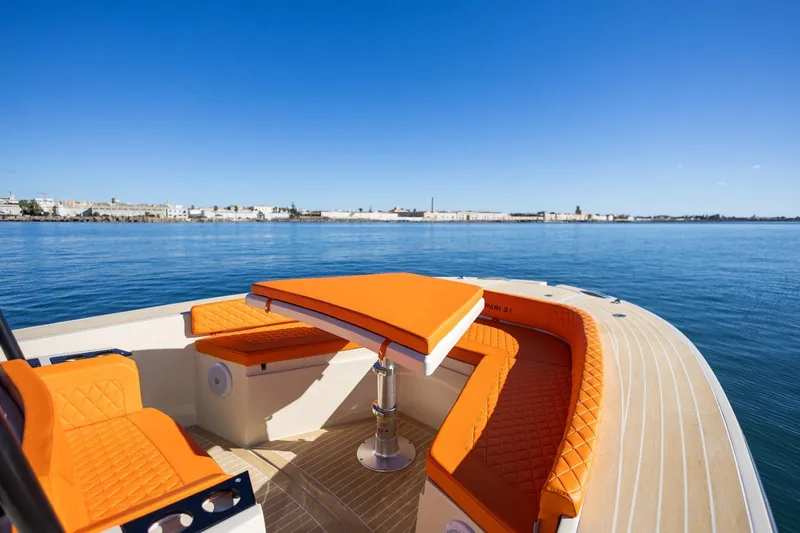  Yacht Photos Pics 2025 AlCustom LIPARI 31 boat with vibrant orange seating on calm water.