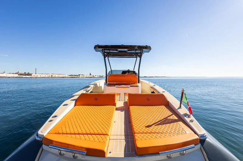  Yacht Photos Pics 2025 AlCustom LIPARI 31 boat with orange seating, cruising on calm blue waters.
