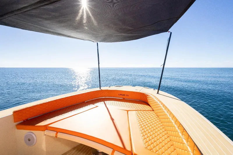  Yacht Photos Pics Modern AlCustom LIPARI 31 boat with orange seating, sunshade, and ocean view, 2025 model.
