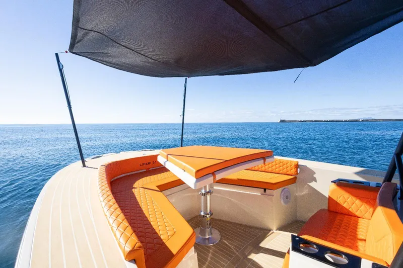  Yacht Photos Pics Luxurious AlCustom LIPARI 31 yacht with orange seating, ocean view, and sunshade, 2025 model.