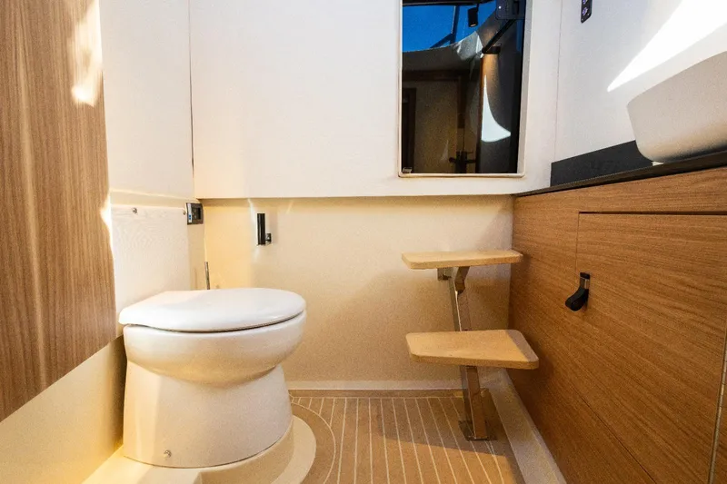  Yacht Photos Pics Modern bathroom interior in 2025 AlCustom LIPARI 31 yacht, featuring wooden accents and compact design.