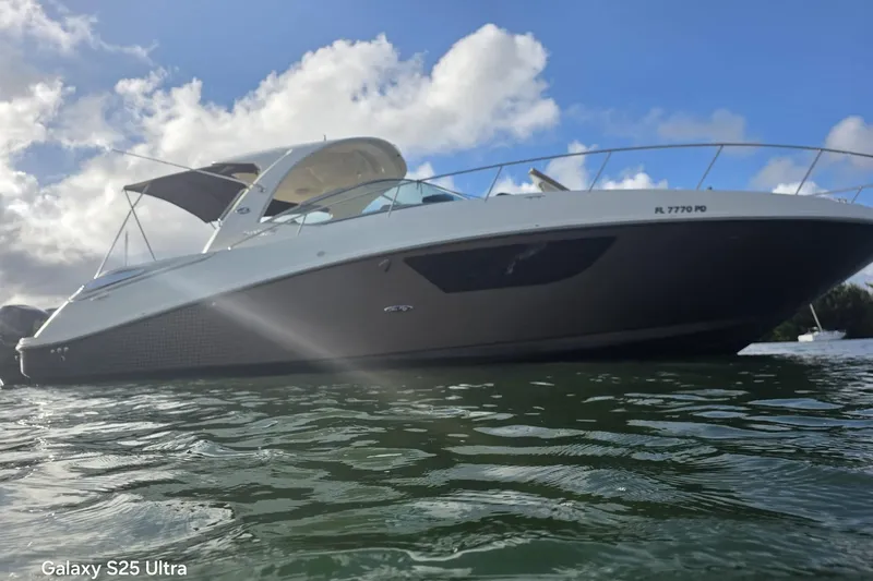 3 Mercury 400 Outboards Yacht Photos Pics 2010 Sea Ray 370 Sundancer yacht on water under cloudy sky.