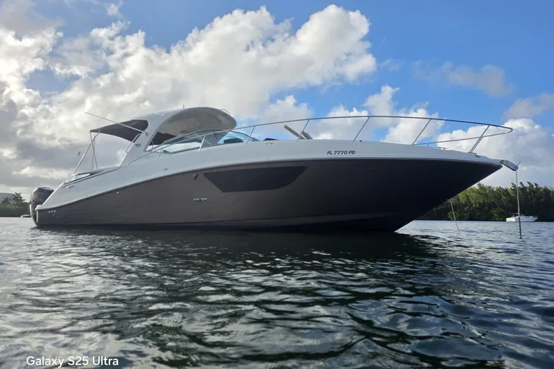 3 Mercury 400 Outboards Yacht Photos Pics 2010 Sea Ray 370 Sundancer yacht on calm water under a partly cloudy sky.