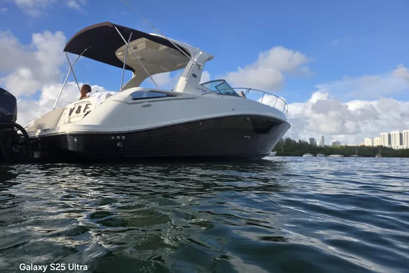 3 Mercury 400 Outboards Yacht Photos Pics 2010 Sea Ray 370 Sundancer boat on water under clear blue sky.