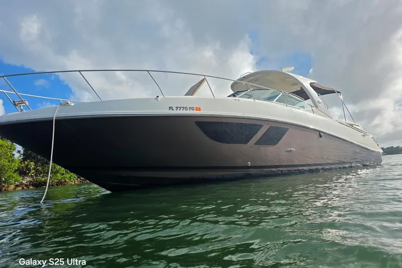 3 Mercury 400 Outboards Yacht Photos Pics 2010 Sea Ray 370 Sundancer yacht on water under cloudy sky.