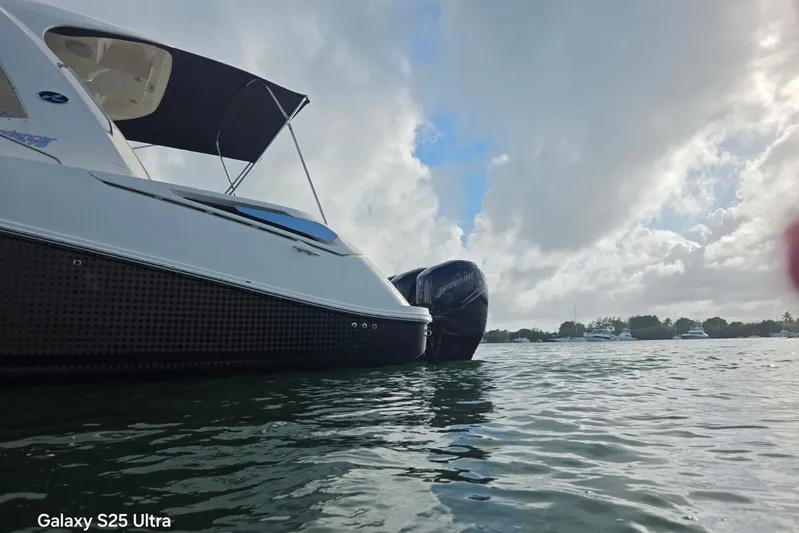 3 Mercury 400 Outboards Yacht Photos Pics 2010 Sea Ray 370 Sundancer on water, cloudy sky background.
