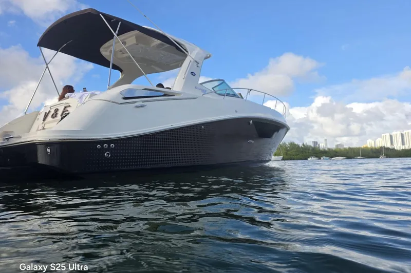 3 Mercury 400 Outboards Yacht Photos Pics 2010 Sea Ray 370 Sundancer yacht on calm water under blue sky.