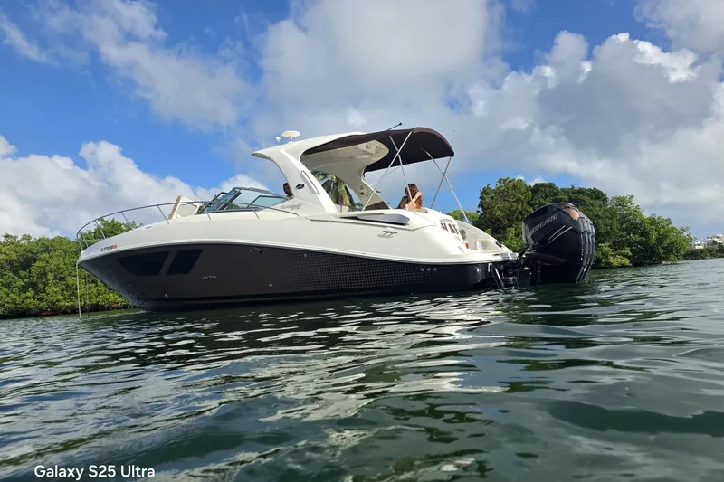 3 Mercury 400 Outboards Yacht Photos Pics 2010 Sea Ray 370 Sundancer boat on water, under a clear blue sky.