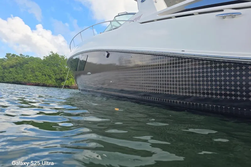 3 Mercury 400 Outboards Yacht Photos Pics 2010 Sea Ray 370 Sundancer yacht on calm water, showcasing sleek design.