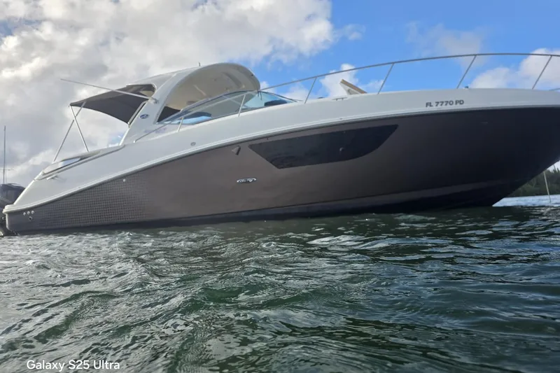 3 Mercury 400 Outboards Yacht Photos Pics 2010 Sea Ray 370 Sundancer yacht on water under cloudy sky.