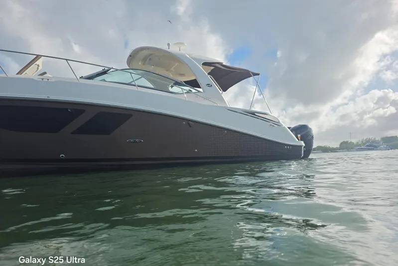 3 Mercury 400 Outboards Yacht Photos Pics 2010 Sea Ray 370 Sundancer yacht on water under cloudy sky.