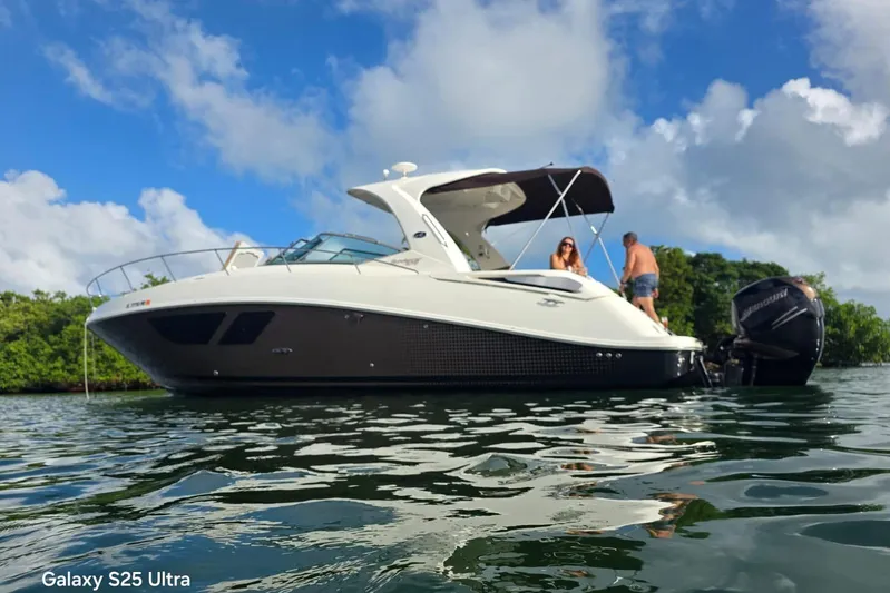 3 Mercury 400 Outboards Yacht Photos Pics 2010 Sea Ray 370 Sundancer on water, with people enjoying a sunny day.