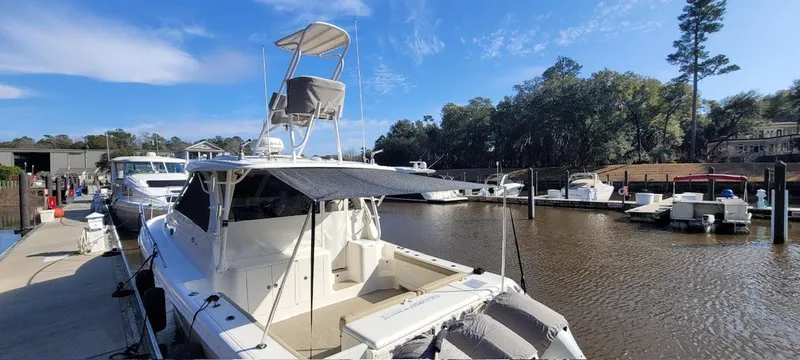  Yacht Photos Pics 2021 Pursuit OS 385 Offshore boat docked at a marina under a clear blue sky.