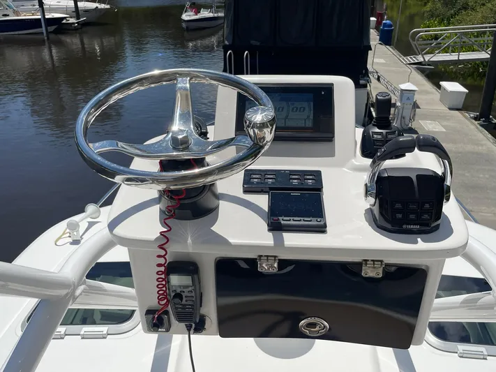  Yacht Photos Pics 2021 Pursuit OS 385 Offshore helm with steering wheel and navigation controls.