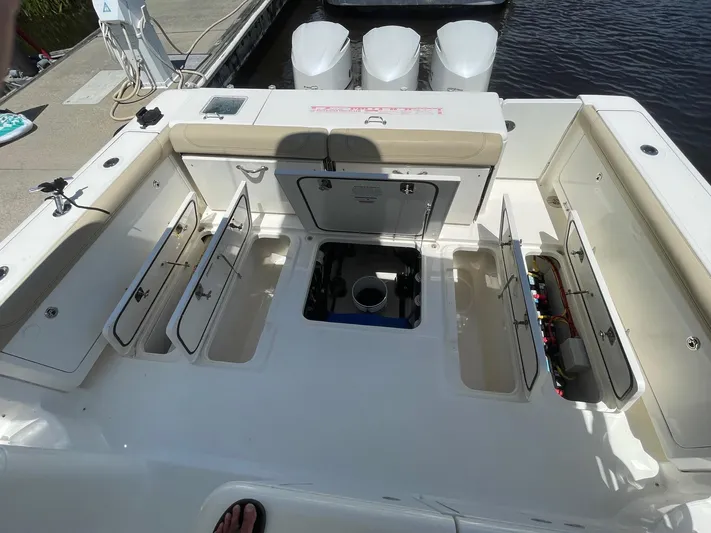  Yacht Photos Pics 2021 Pursuit OS 385 Offshore boat deck with open storage compartments and triple engines.