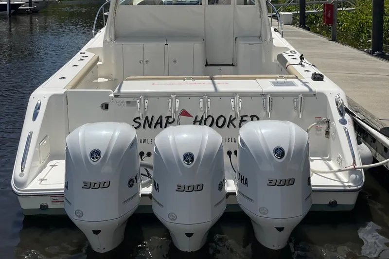  Yacht Photos Pics 2021 Pursuit OS 385 Offshore boat with triple Yamaha 300 engines docked at marina.