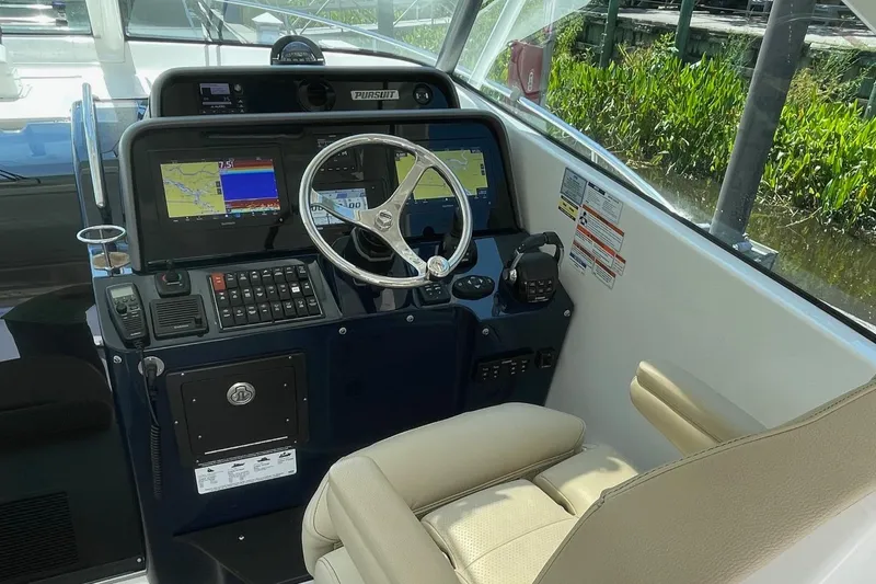  Yacht Photos Pics Helm of 2021 Pursuit OS 385 Offshore boat with navigation screens and controls.