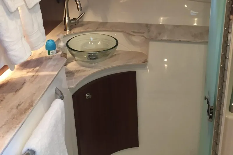  Yacht Photos Pics 2021 Pursuit OS 385 Offshore bathroom with glass sink and marble countertop.