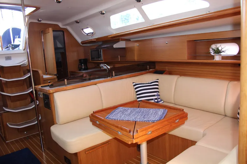 Hannah Yacht Photos Pics Luxurious interior of 2011 Catalina 445 sailboat with cozy seating and elegant wood finish.