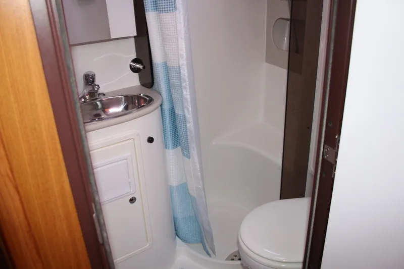 Hannah Yacht Photos Pics Compact bathroom in a 2011 Catalina 445 sailboat, featuring a sink, toilet, and shower.