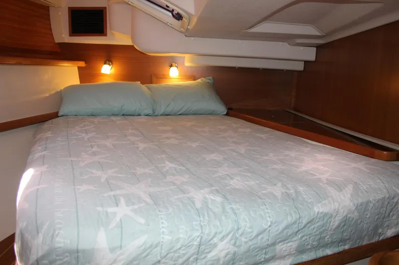 Hannah Yacht Photos Pics Cozy cabin interior of 2011 Catalina 445 sailboat with star-patterned bedding.
