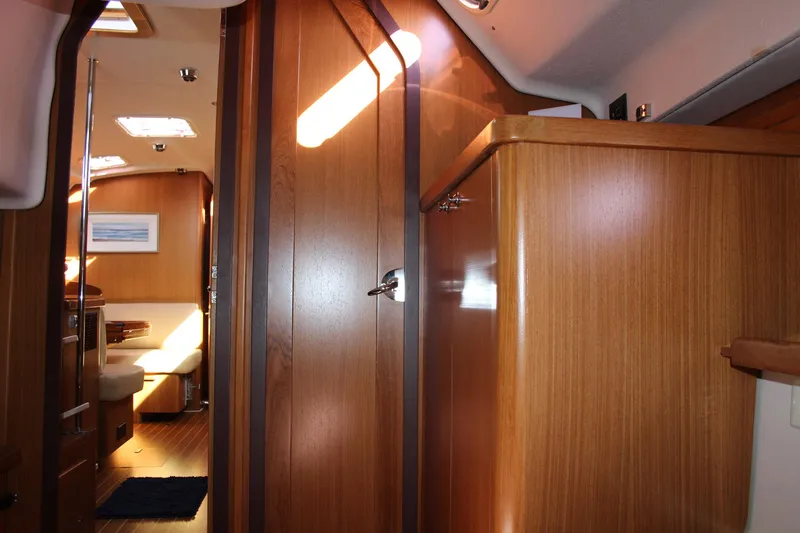 Hannah Yacht Photos Pics Interior of 2011 Catalina 445 sailboat with wooden cabinetry and seating area.