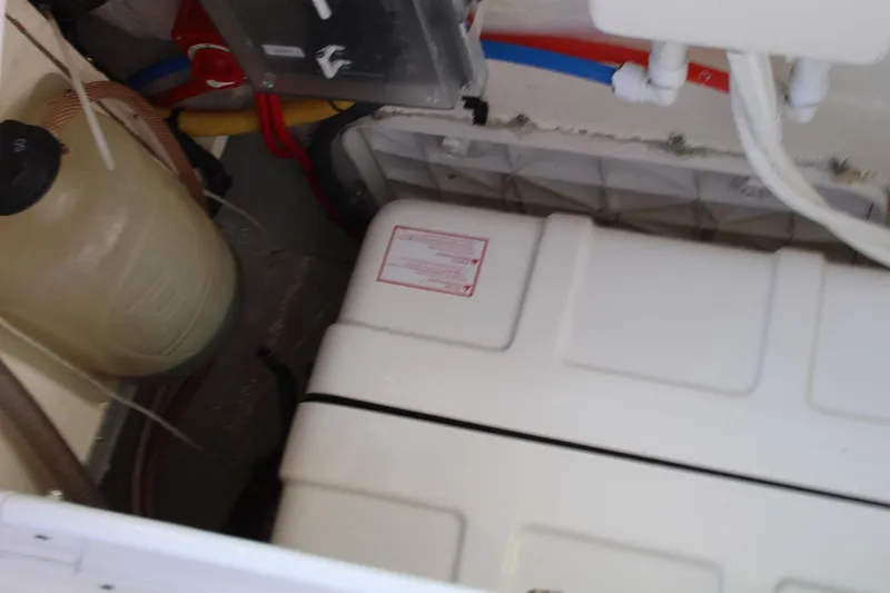 Hannah Yacht Photos Pics Engine compartment of a 2011 Catalina 445 sailboat, showing tanks and hoses.