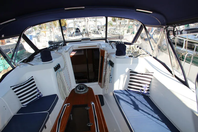 Hannah Yacht Photos Pics Interior view of 2011 Catalina 445 sailboat cockpit with blue cushions and nautical decor.