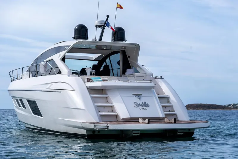 Yacht Photos Pics Luxury 2020 Filippetti S55 yacht on calm sea, rear view with flags.