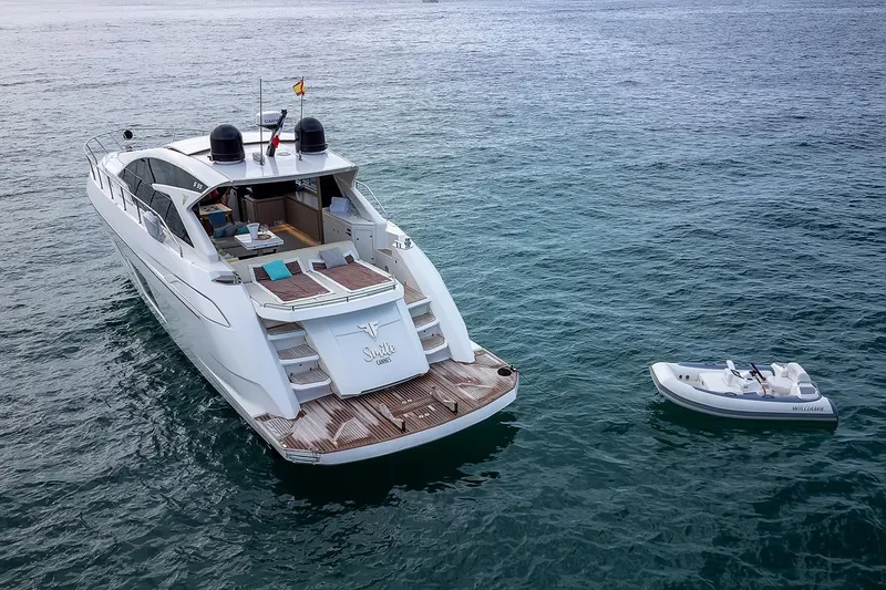  Yacht Photos Pics 2020 Filippetti S55 yacht on open water with a small tender nearby.