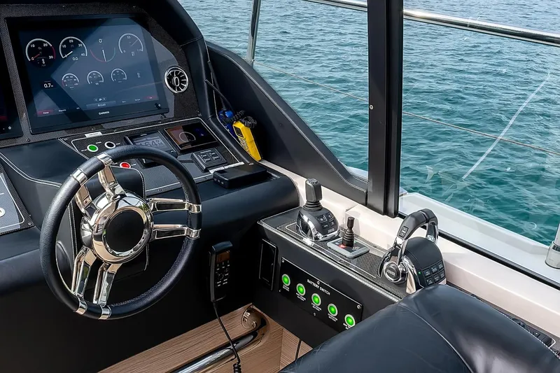  Yacht Photos Pics Control panel of 2020 Filippetti S55S yacht with steering wheel and navigation instruments.