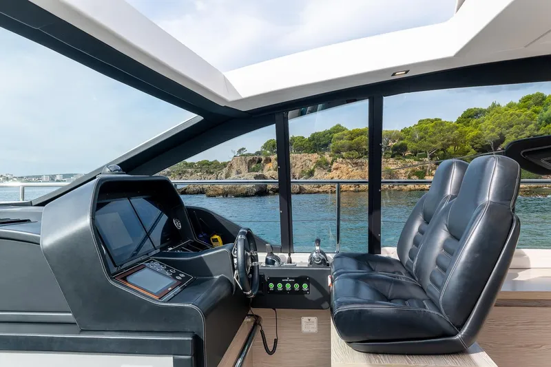  Yacht Photos Pics Interior view of 2020 Filippetti S55S yacht cockpit with luxurious seating and scenic ocean backdrop.